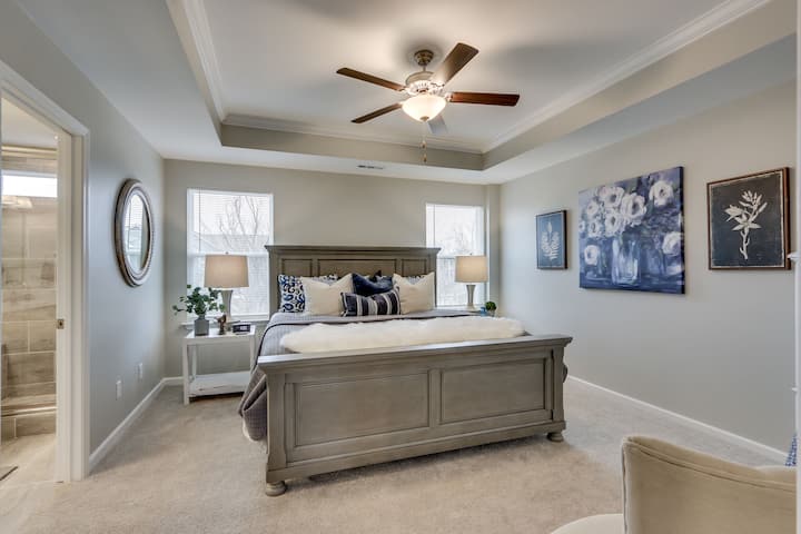 The uber-cozy primary Bedroom with king bed and new firm memory mattress is extremely peaceful on the third floor with ensuite bathroom with double vanity and large shower, large walk-in closet and 45" LED smart TV with streaming plus hair dryer, iro