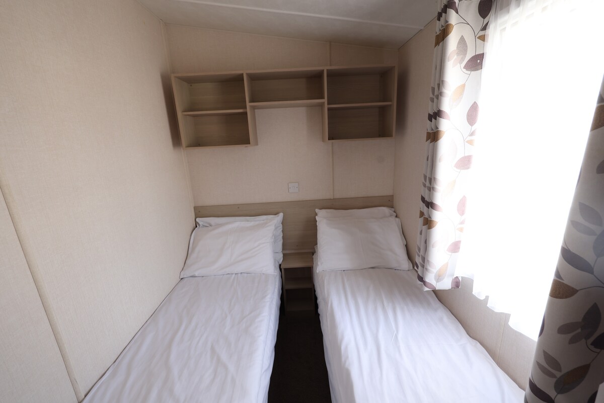 غرفة نوم تضم سريرين صغيرين