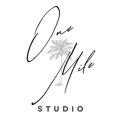 The charming logo for One Mile Studio features the name elegantly scripted alongside a palm tree illustration. The clean design emphasizes a coastal vibe, highlighting a serene and inviting environment.