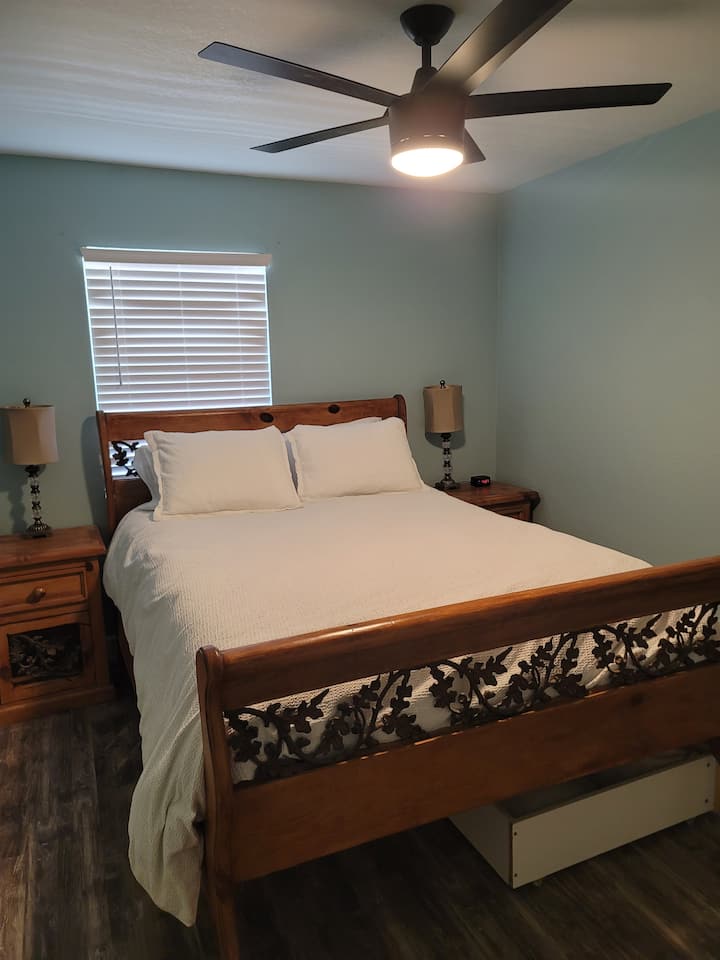 Queen size bed with two nightstands and a large closet.  This bedroom sits facing the front of the house.