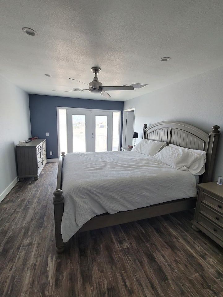 Master bedroom with Cal King bed, large walk-in-closet, two balconies and an on-suite.  Bathroom has a walk-in-shower and stand alone bubbling bathtub & two sinks surrounded by marble counter tops.