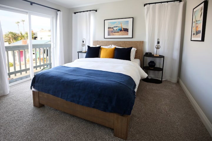 Bedroom 1. Master: A restful night sleep in a Pottery Barn queen bed with Parachute linens and blackout curtains. Pottery Barn console table features make up mirror and seating. 

Balcony to the right through sliding glass door.