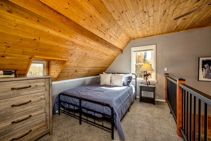 Queen bedroom in the loft. This space has 2 queen beds and a trundle bed. Cozy space!