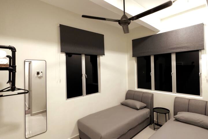 "Perfect for Groups or Families: Third Bedroom Features Two Single Beds for Flexible Sleeping Arrangements!"