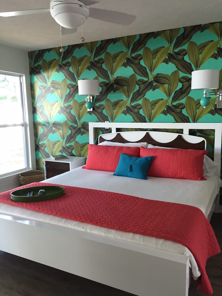 Downstairs Primary Bedroom with Sliding Door overlooking lake and private back patio