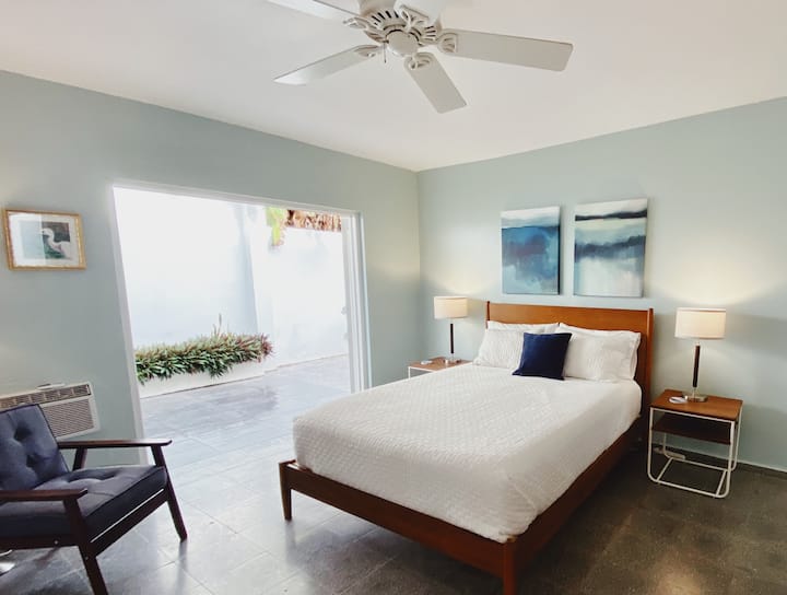Updated main guestroom features queen bed, ensuite bath and french doors leading to private terrace.