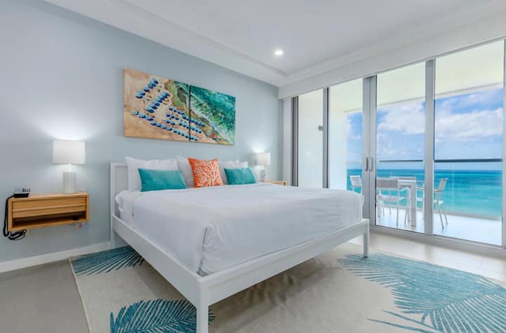 The primary bedroom features a king sized bed, and amazing sea view and an en-suite bathroom with 2 sinks.  Can you imagine waking up to that view?
