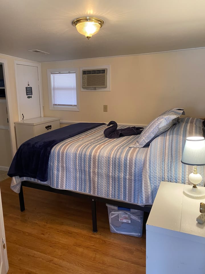 This room is a walk through bedroom. It has a queen bed, and dresser. The washer, dryer combo are located here also 