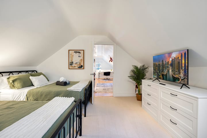 Slaapkamer op de bovenste verdieping met 2 queensize bedden. Een kamer met een Afrikaans thema net buiten de badkamer hier :)