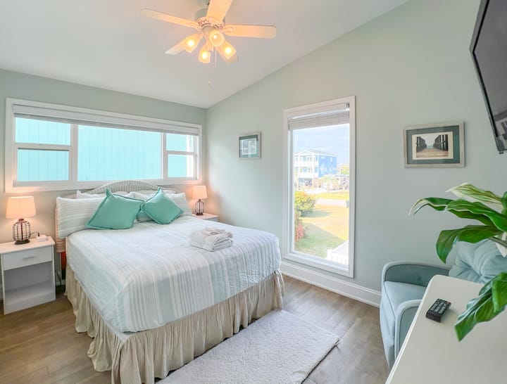 Bedroom 2: Another upstairs primary bedroom featuring a queen bed, 2 nightstands, dresser, wifi tv, closet, and luggage rack.