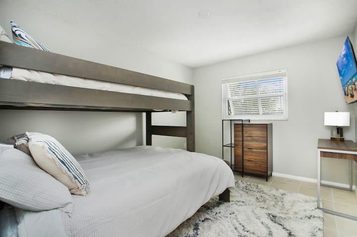 Queen and full-sized bunk beds with a gaming console