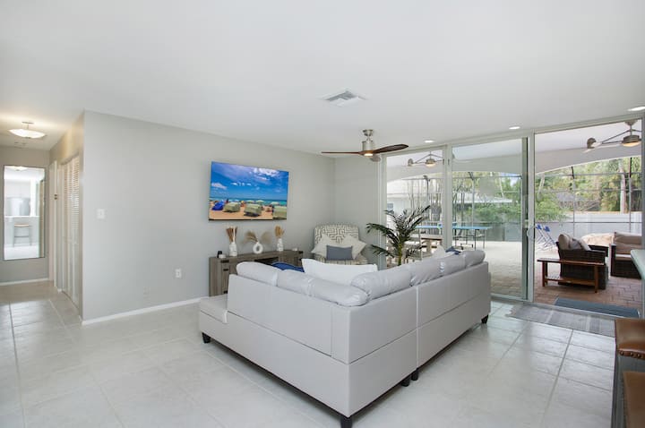 Bright open-concept living room, steps to the pool and backyard oasis