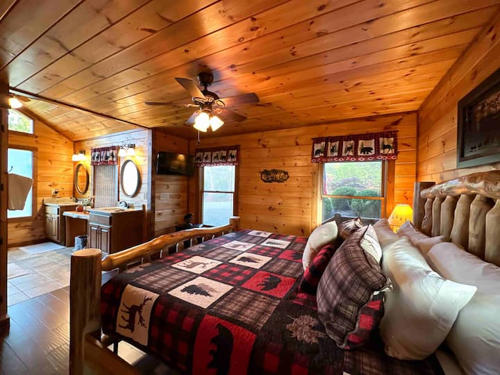 Main level primary room hosts a King bed with custom walk in shower.