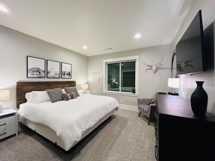 King bedroom with all of the comforts.  Wall-mounted TV above the dresser.  Plenty of closet space.