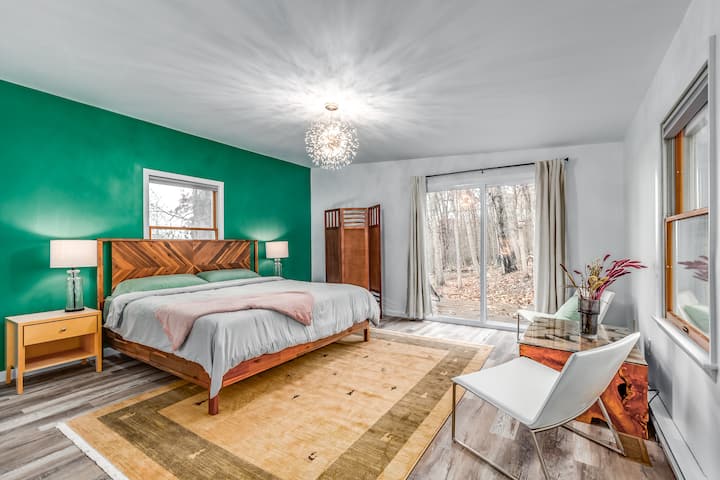 Bedroom Oasis: Vibrant decor and forest views make every stay memorable and refreshing!