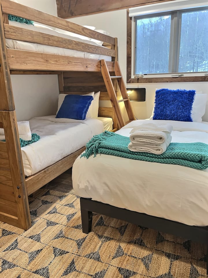 Twin size bunk bed paired with a single bed.