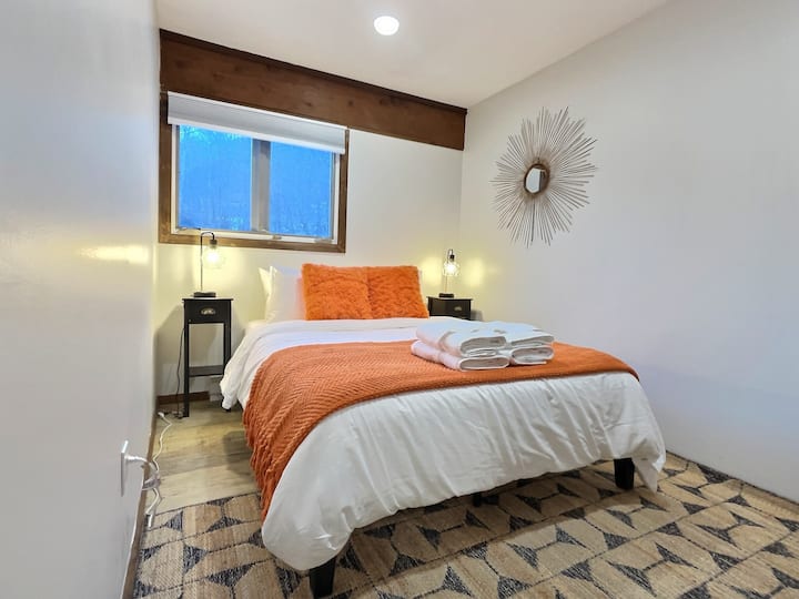 Relax in our comfortable queen bedroom, offering a cozy retreat for a restful night's sleep.