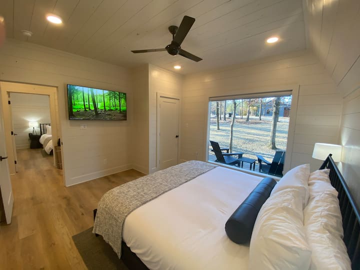 Cozy modern bedroom with scenic window views and calming decor.