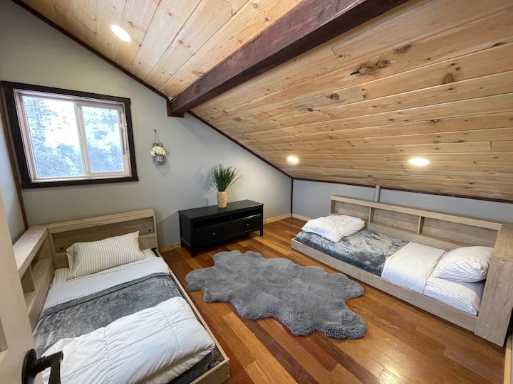 Upstairs bedroom with two twin beds.