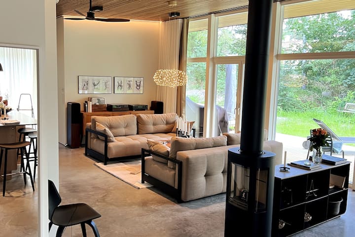 Living room with glass sections from floor to ceiling.
