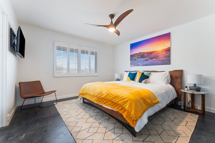 Primary bedroom has seating and wall mounted 43" smart Samsung TV.  Comfortable hybrid mattress.