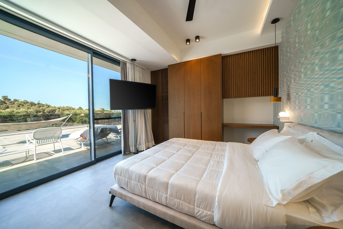 First floor bedroom with access to shared balcony with seating area and hammock.