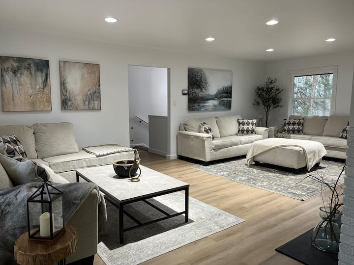 Full living room view with woodburning fire place and 65" TV