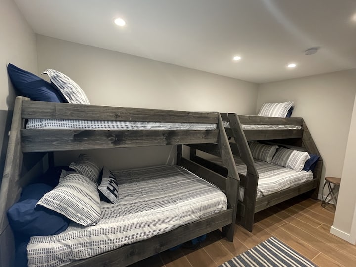 Bunk beds with 2 full beds on bottom, twin bed on top.
