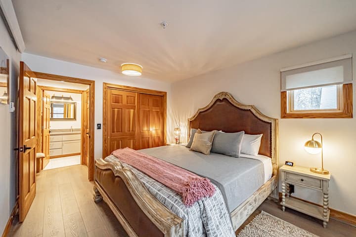 The bedroom has plenty of space and easy access to the bathroom.