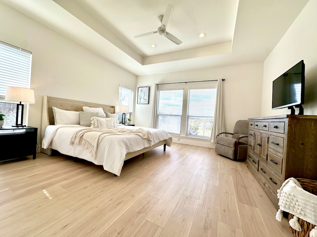 חדר שינה ראשי עם מיטת קינג סייז וטלוויזיה