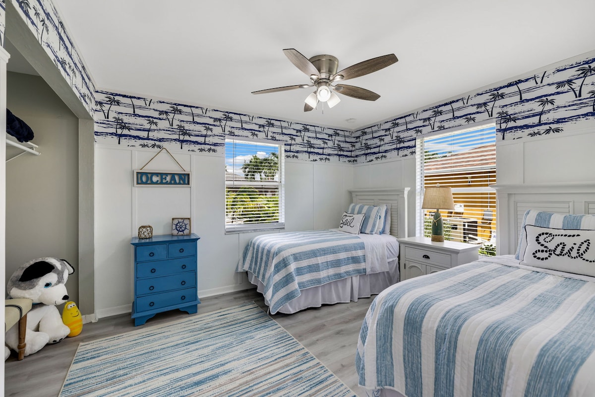 Rest easy in the master bedroom featuring a plush king-sized bed, vibrant decor, and ample natural light. The modern design and cozy ambiance create the perfect retreat for a peaceful night's sleep. Enjoy the comfort and tranquility.