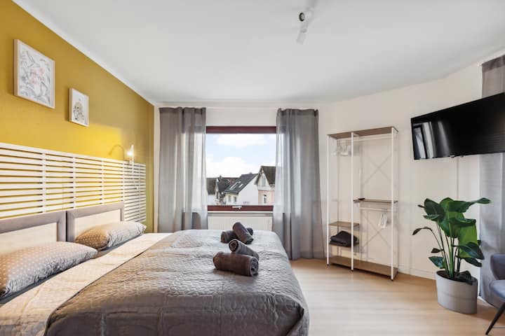 Bedroom 2 with two single beds that can be joined to create a large double and an open wardrobe system. Each bedroom also includes a smart TV.