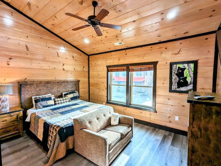 Bedroom 7 with high ceiling and sofa. 