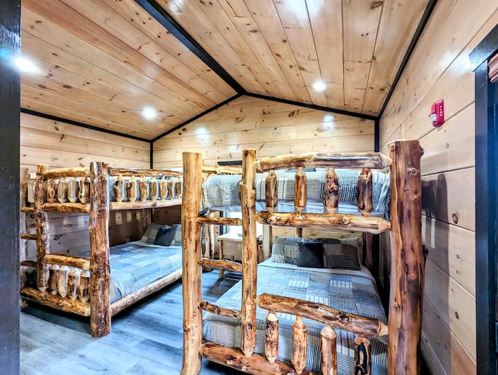 Bedroom 3 with mountain view, patio access is equipped with its own ensuite bathroom and features two queen-size bunk beds, providing comfortable accommodations for up to 8 guests. 