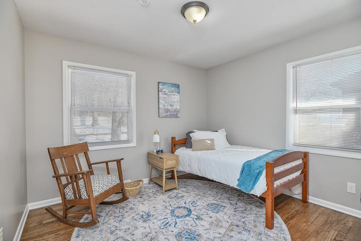 Bedroom on the main floor.  Room includes full sized closet and rocking chair.  Bed can remain single or be paired with the other bed to make a bunk bed.  