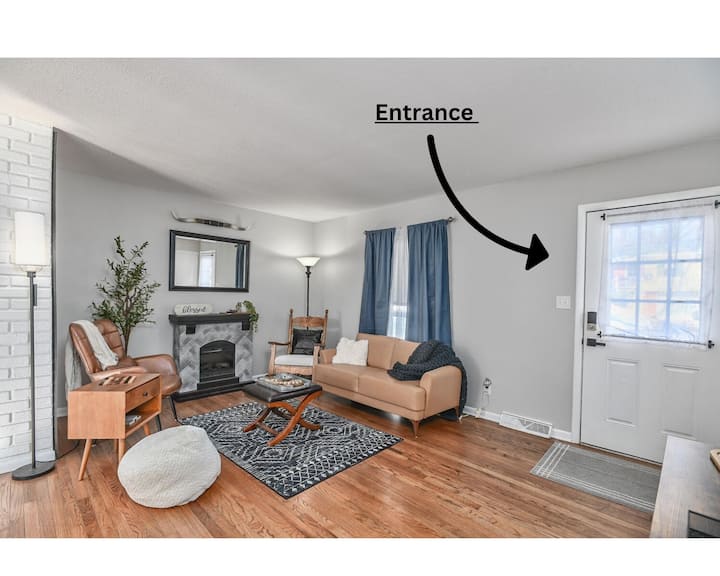 Living room #1 - on main level - with electric fireplace, an antique rocker, and mid-modern century style leather seating.