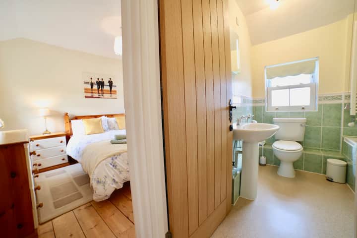 The king sized bedroom benefits from a large en suite bathroom with hand held shower attachment. 
