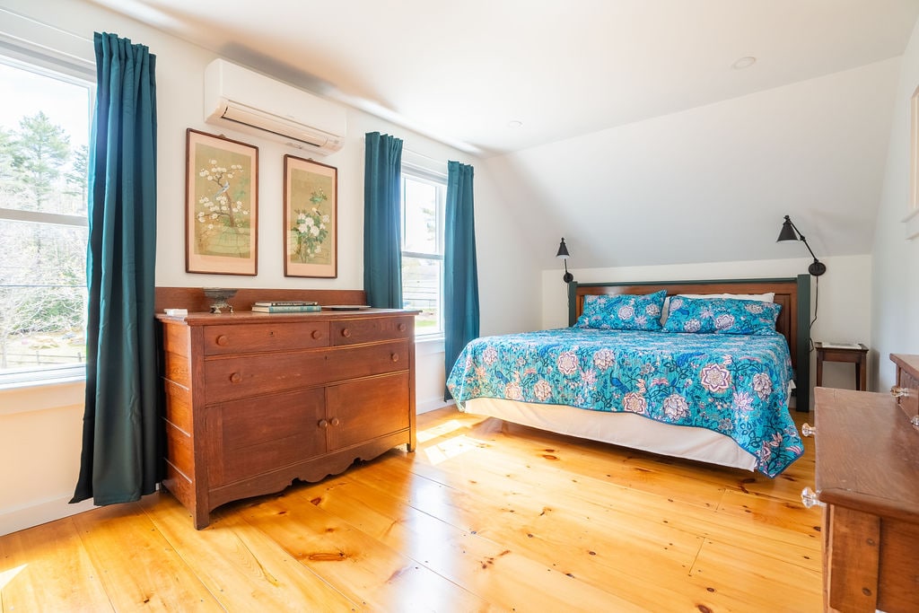 One of two bedrooms upstairs has a king-sized bed with Coop pillows. An antique dresser and large closet provide ample storage for your effects. Blackout curtains ensure you'll get a good night's sleep.