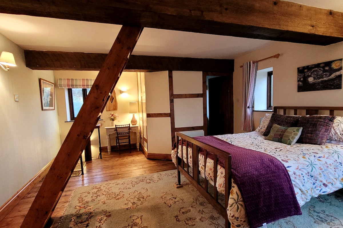 Bedroom with dressing table area and stairs to the Top Floor.