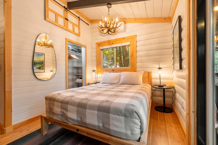 The first bedroom has a beautiful queen size bed and a closet. There is also a slider door that leads right out to the deck and hot tub.