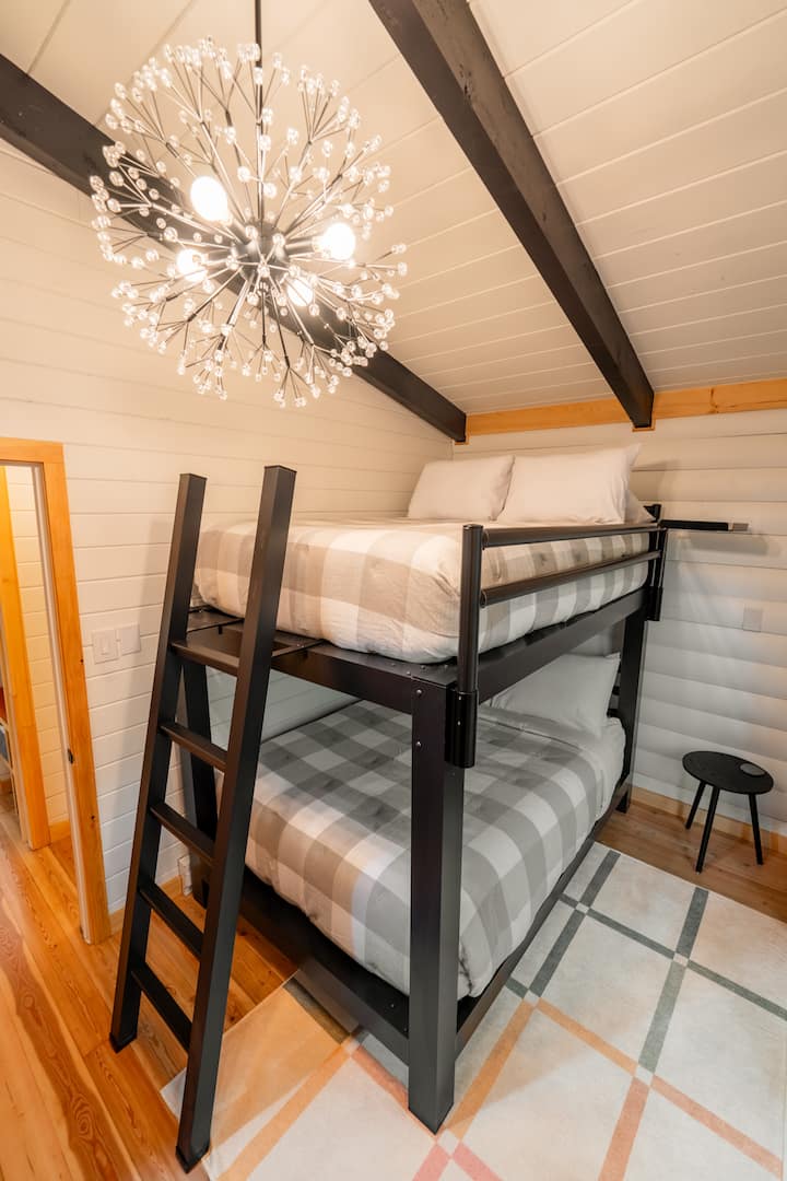 The second bedroom has a bunk bed set with two adult full-size beds.