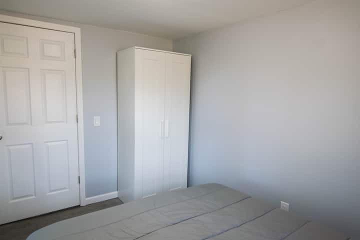The master  bedroom has a wardrobe with clothes hanging bar and space for items the size of carry-on luggage.