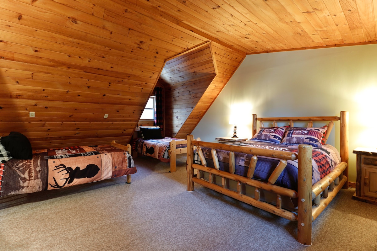 The upstairs loft has a queen bed and two twin beds. It also makes a great play area for the kids.  