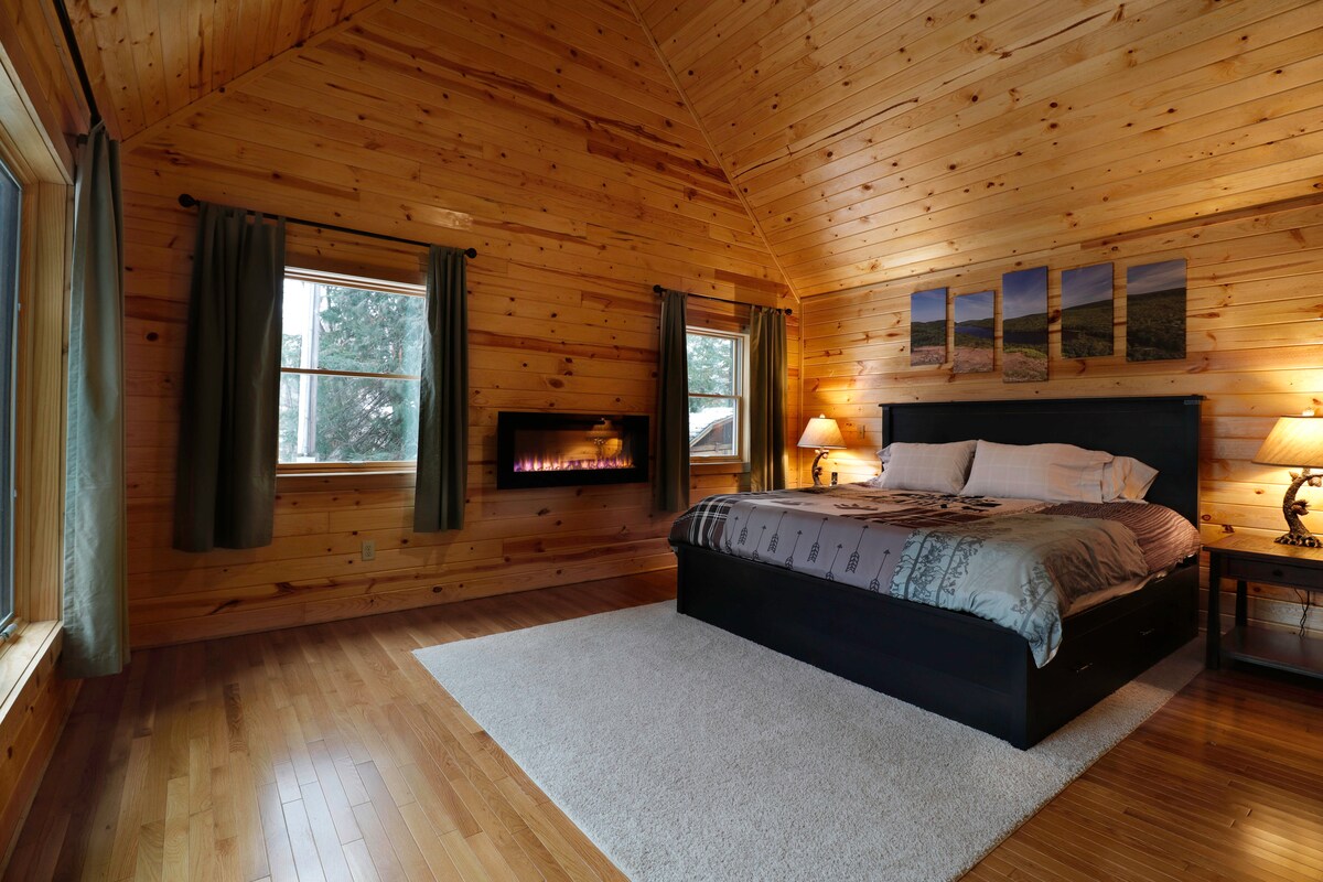The master bedroom has a king bed and electric fireplace to keep this room cozy on chilly nights. 