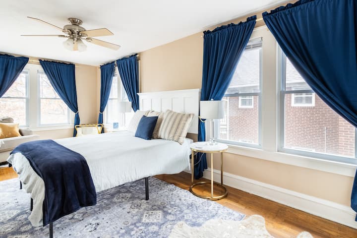 This spacious Queen bedroom features a custom headboard, crystal lamps and marble bedside tables.  For your convenience, there are two universal phone chargers on either side of the bed as well.  There is also a white noise machine for your comfort.
