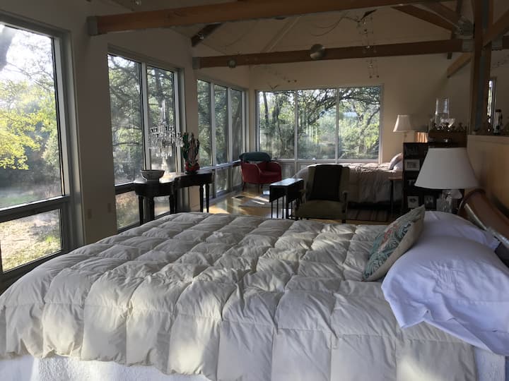 Large bedroom, two beds, lots of windows, great views, and beautiful light