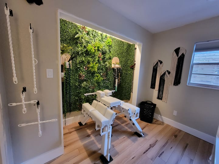 Are you ready to be one with nature? This is our Greenhouse, aka "The Plant Daddy Room." This room features a bed from DungeonBeds and adult furniture from Fedora Fabrications. And look at that plant wall. Imagine taking photos in front of that!