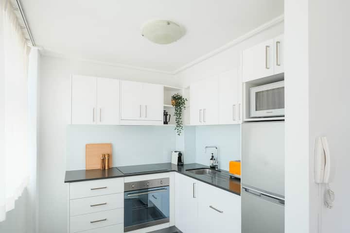 Fully equipped kitchen with induction stove and Smeg oven.