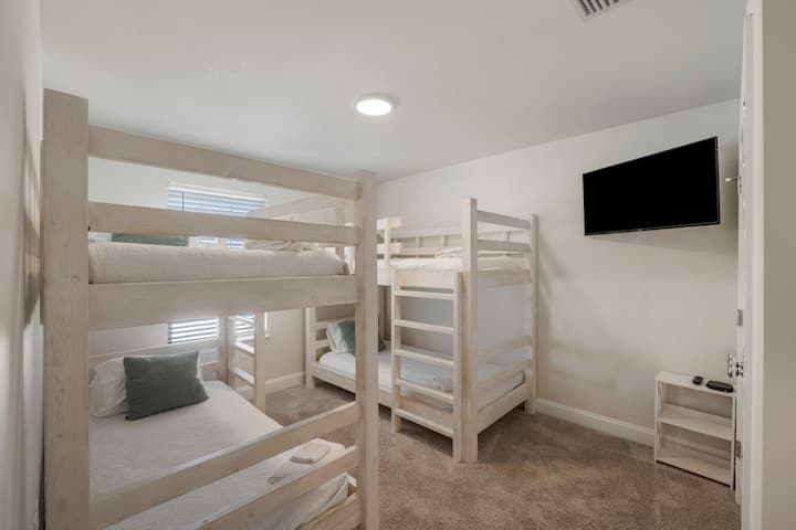 [Bunk room, Upstairs] 

Bunk room boasts a double-set of sturdy bunks for kids and adults, plus a Roku‑enabled TV and remote workstation with desk and ergonomic chair. Double the bunks, double the fun! A kid‑favorite space ideal for work or play.