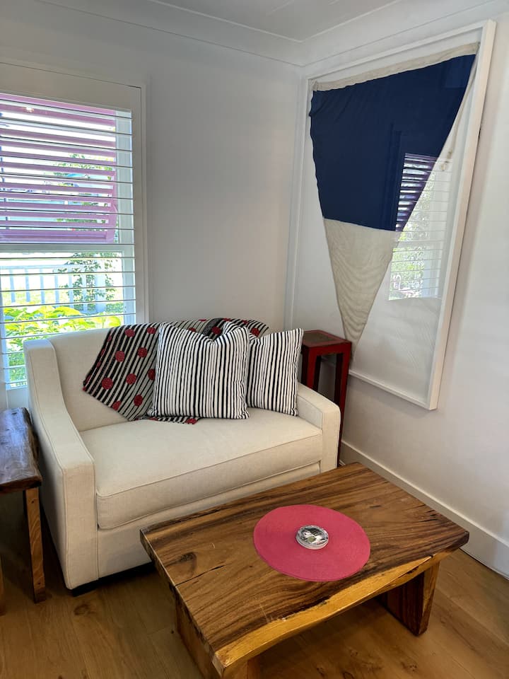 The twin love seat pulls out to a sofa bed. It is located in the kitchen area 